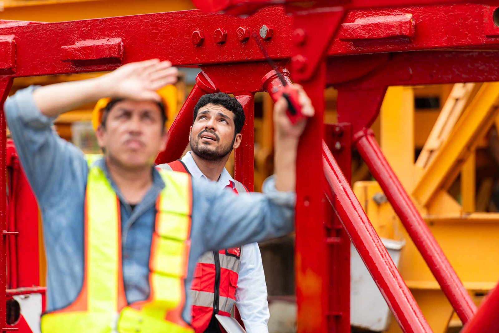 Portrait of crane worker on construction crane inspection is made to transport the crane from storage to be assembled on the building construction site